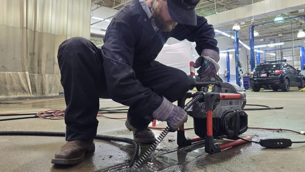 A Professional Expert Drain Cleaning Technician with Befort Plumbing & Heating Clearing a Commercial Drain