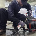 A Professional Expert Drain Cleaning Technician with Befort Plumbing & Heating Clearing a Commercial Drain